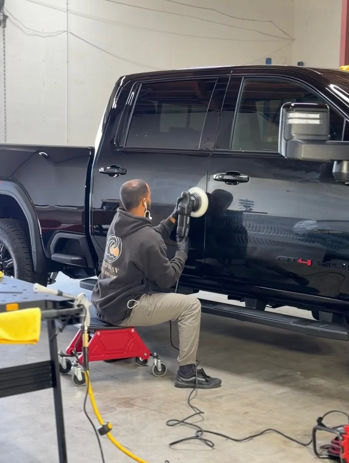 Gustavo machine polishing a truck panel on location
